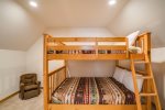 Another bedroom on the upper level with full over full bunk beds sleeps up to 4 people.